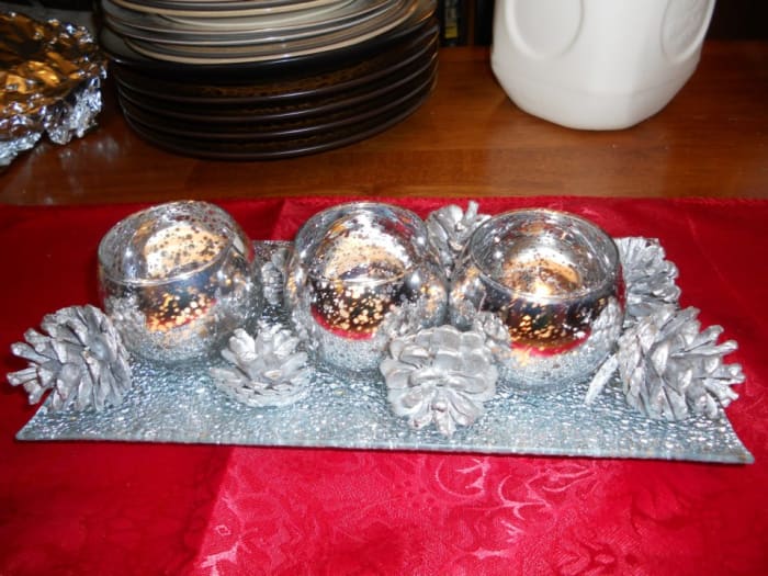 A silver tray, silver candle holders and groupings of pine cones spray painted silver makes a beautiful Christmas centerpiece.