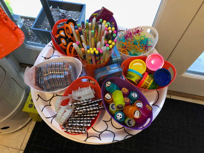 I offer a variety of non food treats and used to keep small containers of each. I had more hidden below a table and would replenish the bins after groups of children left. While visually appealing, it was challenging with large groups of kids.