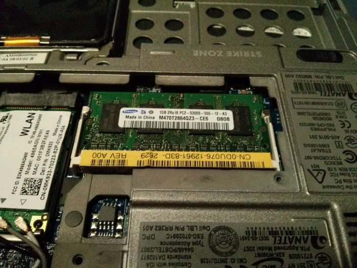 Insert the RAM module into the slot, lining it up with the notch on the card. Slide the card in at roughly a 45 degree angle, then gently press it down until the clips on the side lock it into place.