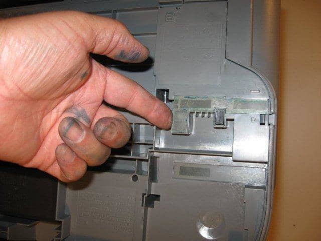There is a plastic film on the bottom of the printer that seems to function as a plug for the chamber that catches all (well most) of the excess ink. Carefully pry this film off.