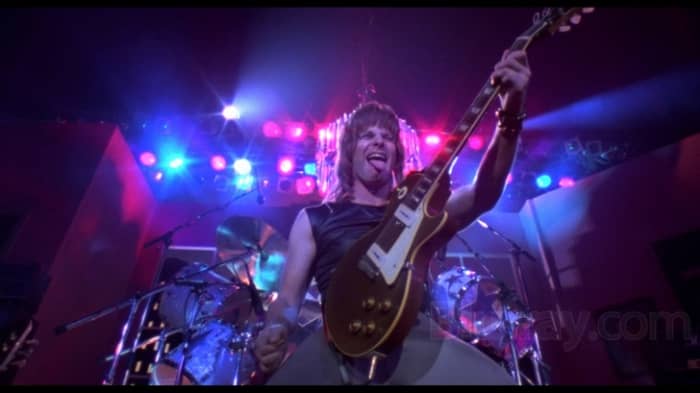 The film pierces the insanity and pomposity of rock band documentaries and performances like a safety pin to a balloon.