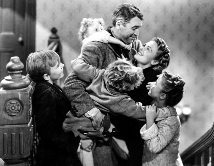 The Bailey Family: (Clockwise from left to right: Larry Simms, Karolyn Grimes, James Stewart, Donna Reed, Carol Coombs-Mueller, and Jimmy Hawkins.