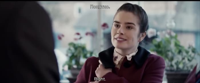 Joanne's red coat, in contrast to the dull colors, signifies the future importance of her character.