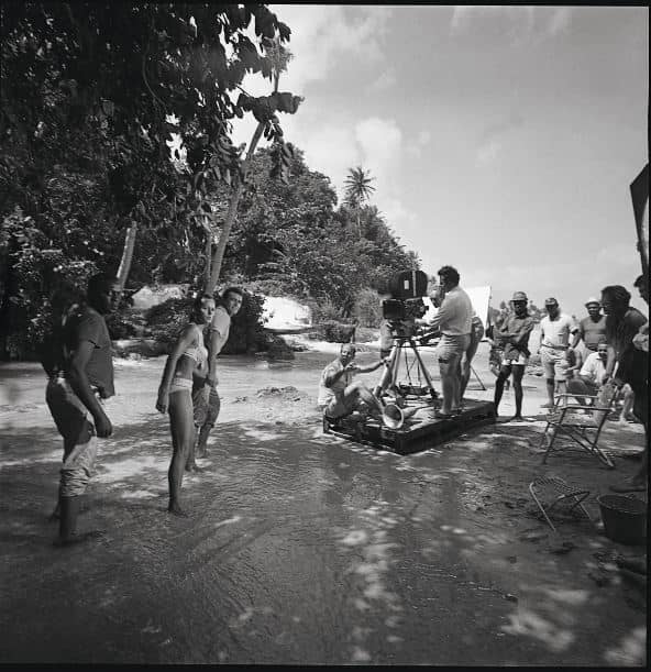 Terence Young positioned under the camera directing Sean Connery, Kitzmiller, Ursula Andress on location in Jamaica.