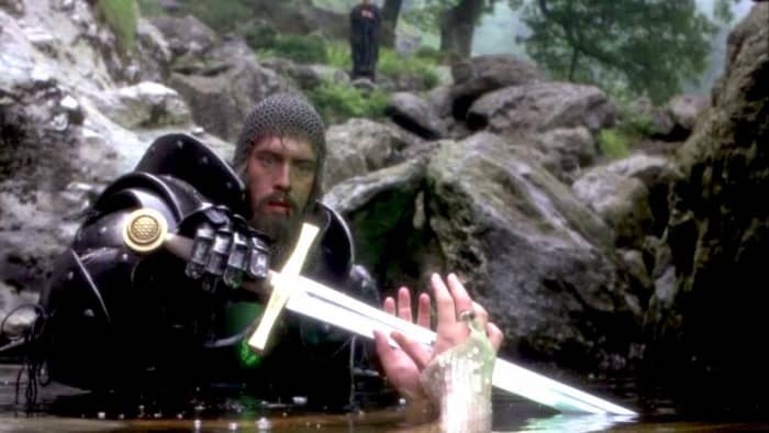 King Arthur (Nigel Terry) reaches for the mended Excalibur from the Lady of the Lake (Hilary Joyalle)