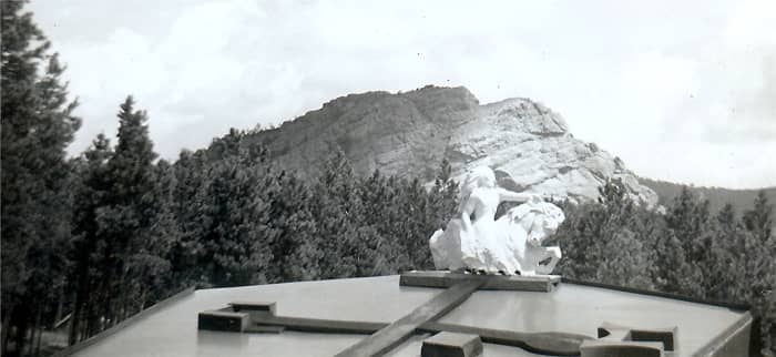 "You can see in the background on the mountain where they have cut out quite a bit with air hammers." (Chief Crazy Horse Memorial, 1950s Photo)