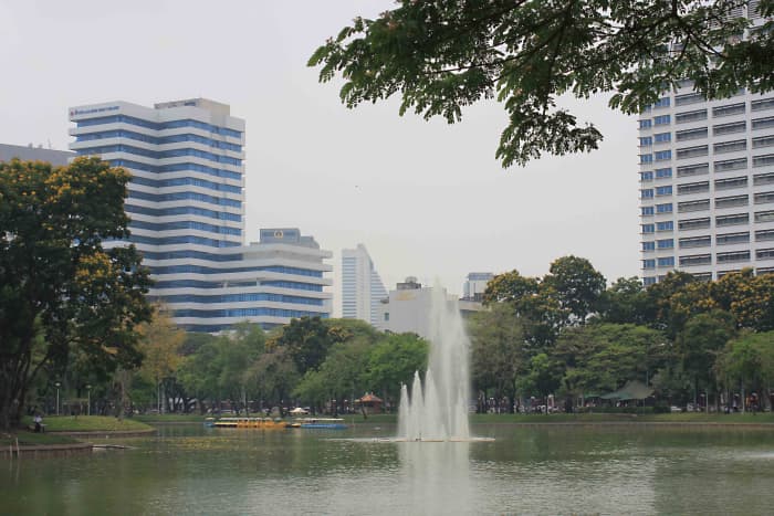 Lumpini Park lake and fountain. The tranquil boating lake is the life-blood of the park and the main attraction for many park visitors - a total contrast to the hectic city beyond