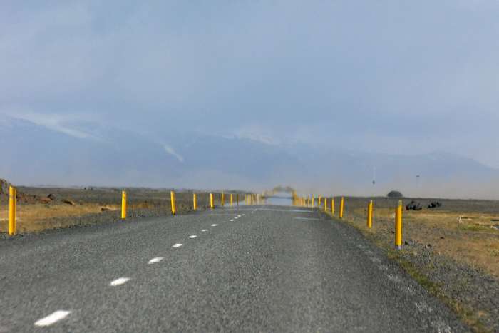 What appears to be water on the road ahead is merely a mirage.