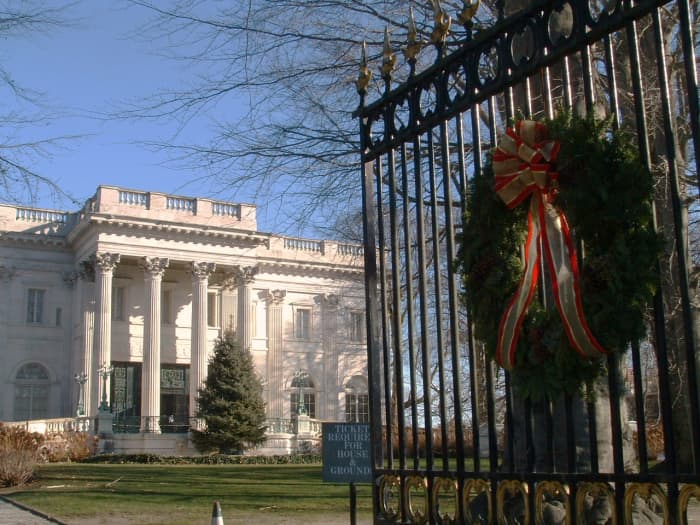 Front entrance gate of The Marble House decorated with a giant Christmas wreath.