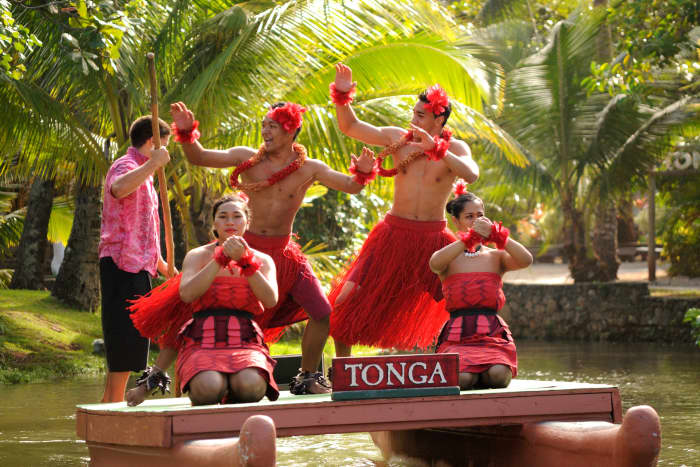 The Parade of Canoes takes place every afternoon at the Polynesian Cultural Center. Tongan dancers perform on a floating canoe in this photo.