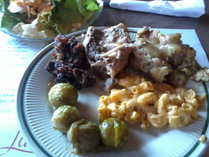 A dainty and delicious salad; Brussels sprouts, real mac and cheese, stuffing with chicken gravy, roasted chicken, and black bean and sausage stew