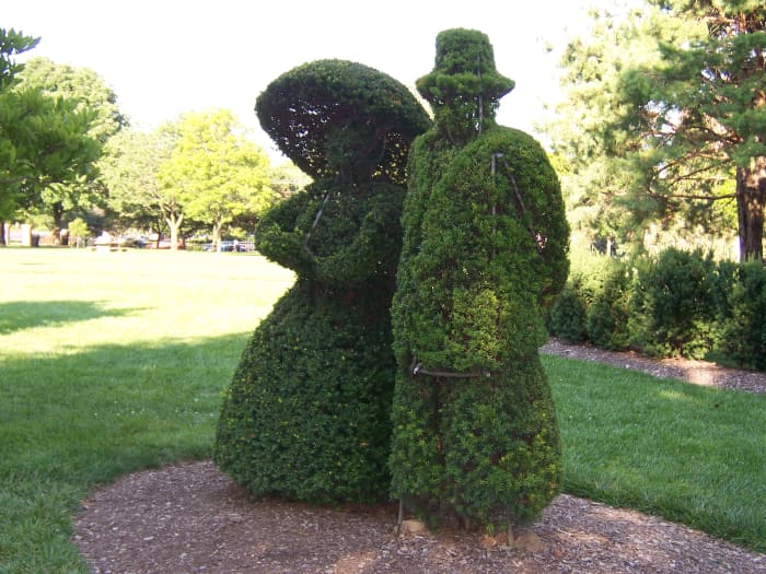 These two topiaries are a part of the whole that recreate a painting of a landscape at this park.