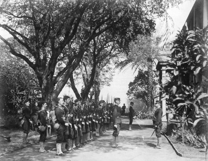 The USS Boston's landing force on duty at the Arlington Hotel, Honolulu, at the time of the overthrow of the Hawaiian monarchy, January 1893.