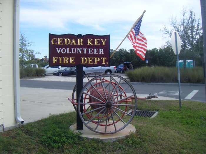 Cedar Key Fire Dept. sign. The beach there is small but very attractive. There are numerous restaurants nearby selling seafood and other cuisine, as well as stores and a local museum.