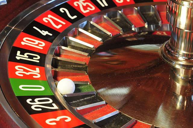 Roulette wheel and single green zero spot.
