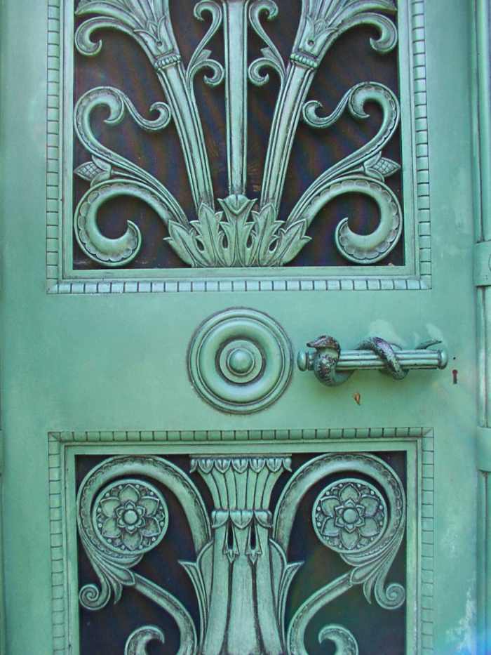 Close up of the Schoenhofen tomb door which shows sylized Egyptian lotus and serpent door handle.
