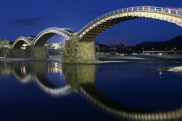 Kintai Bridge displays fine traditional Japanese wood craft. The nighttime illumination combined with the reflection from the river leave a lasting impression.