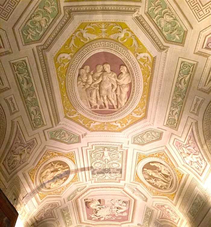 A ceiling in the Vatican Museums gives the illusion of a carved bas relief, however it is actually flat painting using painted shadows to give the illusion.