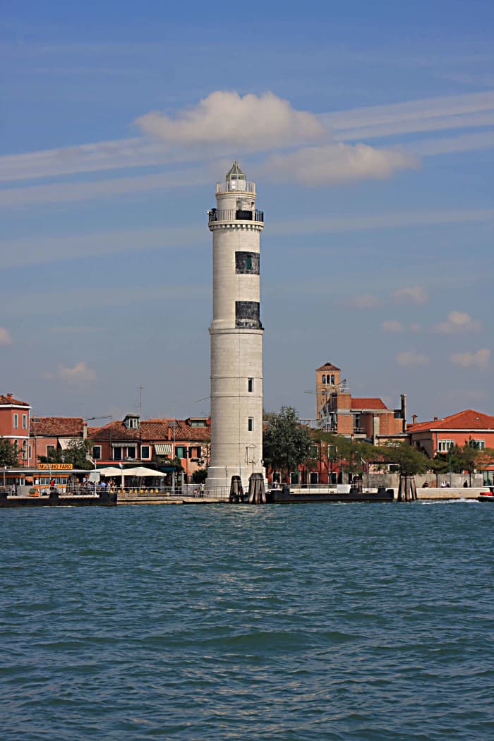 The Murano Lighthouse and the Faro Vaporetto Station. In the distance is the bell tower of Santi Maria e Donato