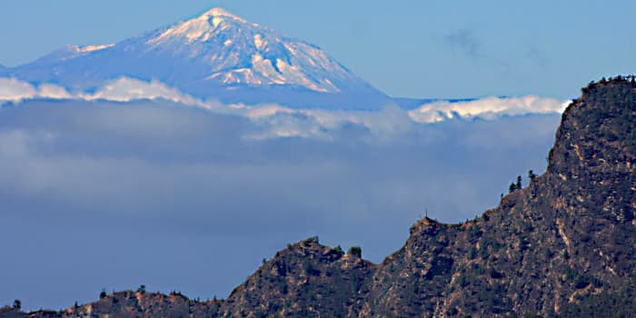 Two islands in one photograph - Gran Canaria and Tenerife. In this image, Mt Teide is about 100 kilometres (62 miles) distant - the Atlantic Ocean which separates the two islands, is lost beneath the clouds