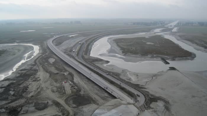 The new elevated causeway on the left. The old causeway on the right will be removed to allow the flow of water under the new causeway.