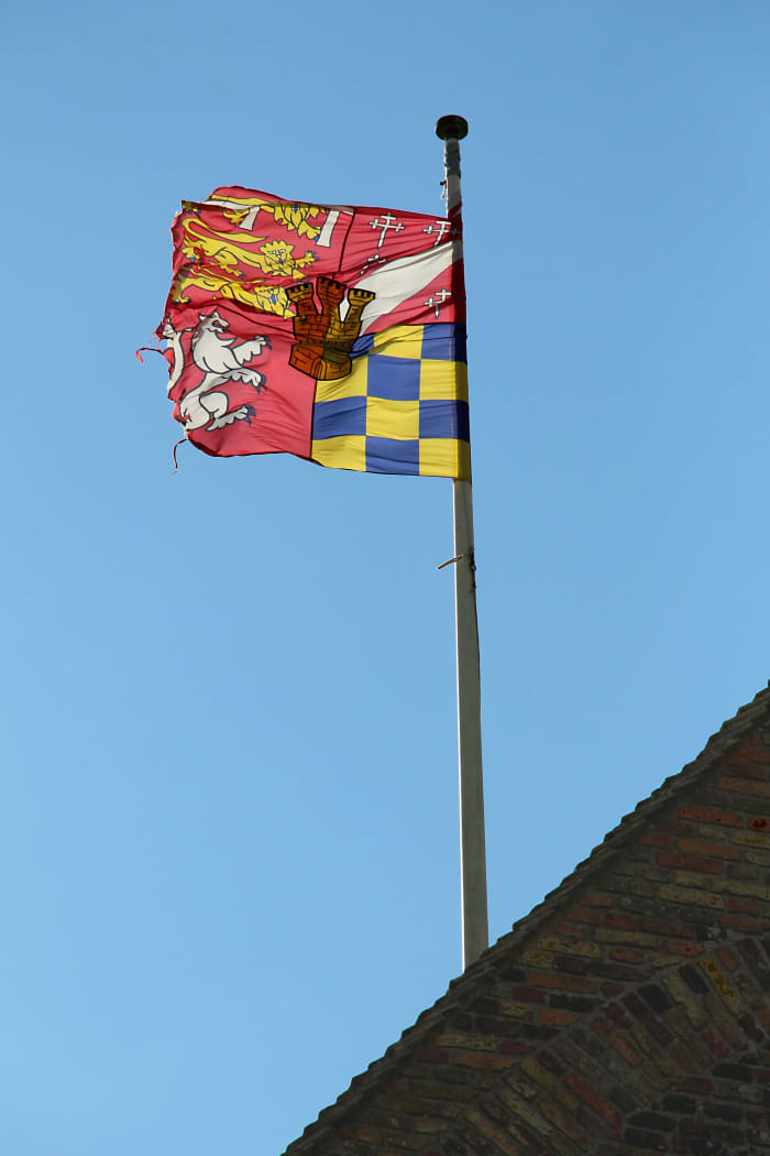 England's flag doesn't fly here - it's the Coat of Arms of the Howard family. Henry VIII sold Castle Rising to Thomas Howard, Duke of Norfolk in the 16th century