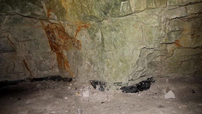 One of the old mines showing the dark band of flint - a precious commodity in the Stone Age. One can descend via a ladder to see the Neolithic stone workings