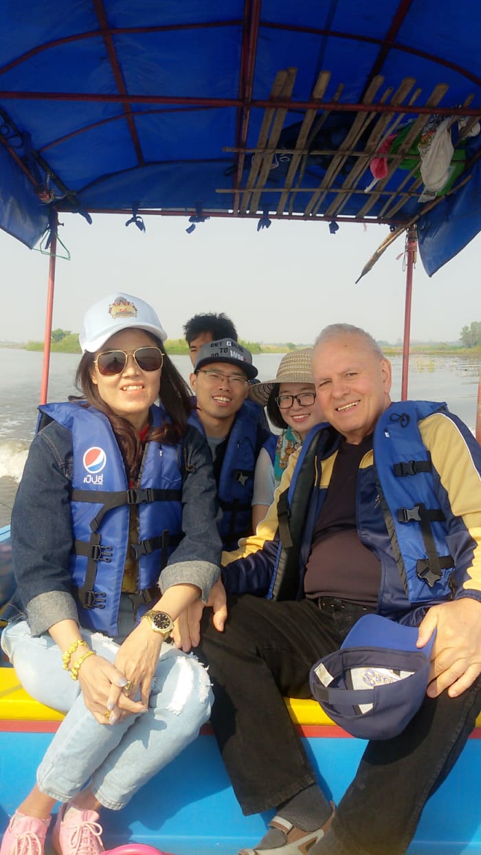 Author pictured next to wife on a boating excursion with friends in Thailand. Picture taken in February 2018.