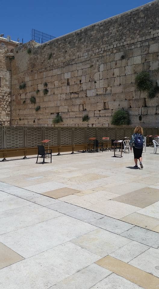 The Western Wall is located in Jerusalem. Here, you can write a prayer on a piece of paper and put it in the wall. This is one example of an area where men and women are separate.