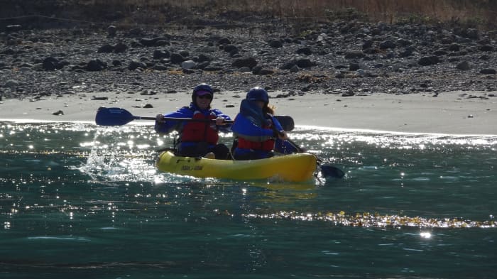 Launching Kayaks at Santa Cruz Island. Having a guide to stabilize the kayak during launch is extremely valuable.