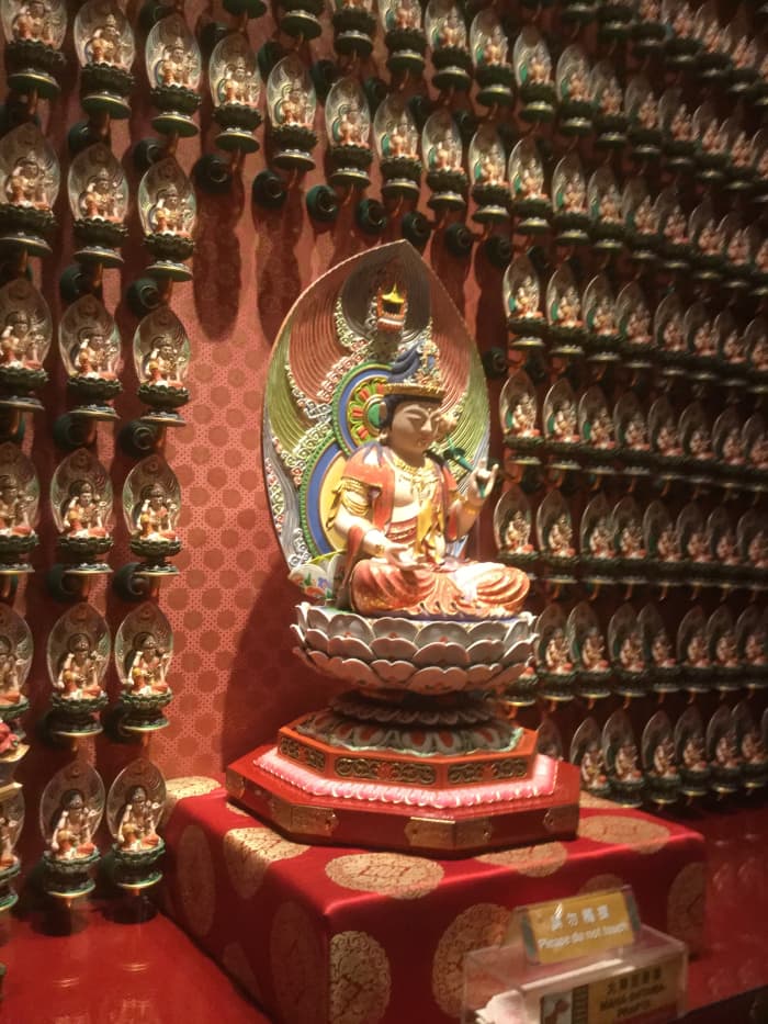 One hundred Buddha statues line this wall on the first floor of the Buddha Tooth Relic Temple. Each individual statue has a name and a specific hand sign, called a mudra.