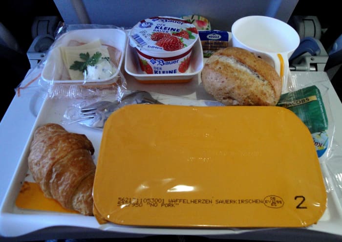 Although people often complain about airline food, the one thing it's got going for it is that the portion sizes are usually quite modest and well-balanced. Sitting in a cramped seat when you are feeling bloated and stuffed is not comfortable.