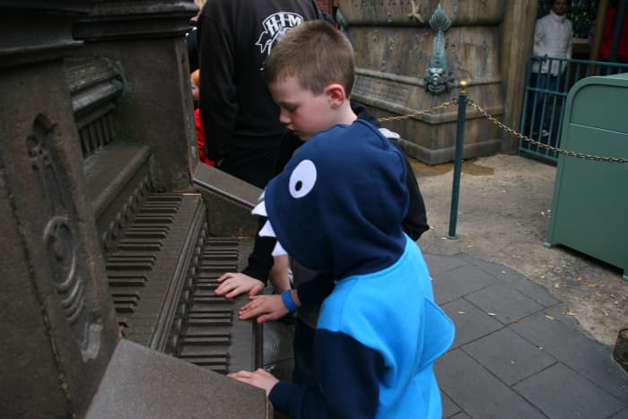 Interactive queue elements, like this pipe organ in the line for the Haunted Mansion, help entertain guests while waiting in line at Disney World.