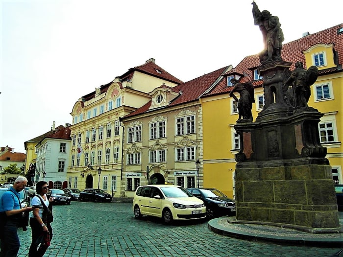 Statue of John the Baptist in the foreground. Turba Palace can be seen behind on Maltese Square.