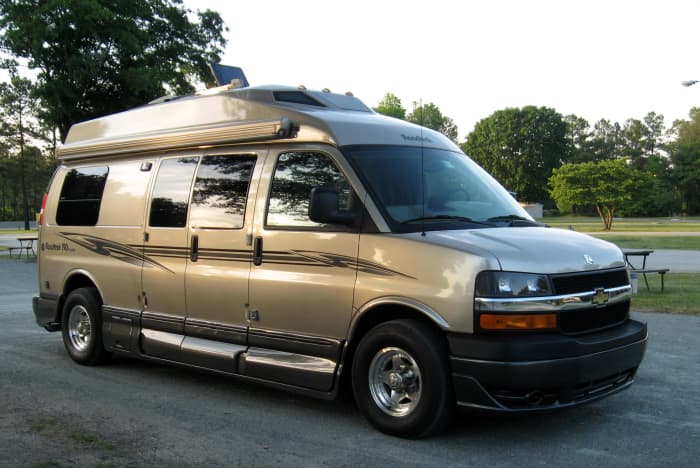 The RoadTrek, a compact but fully-outfitted campervan with a bed, kitchen, bathroom, and more.