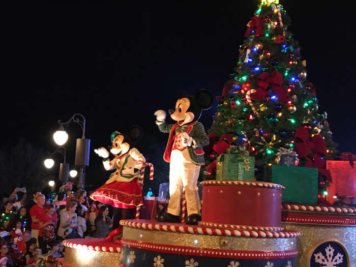 Mickey and Minnie Mouse waving from their float during the parade at Mickey's Very Merry Christmas Party
