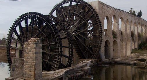 Romans used a water wheel to lift large amounts of water up to the level of their aqueducts that then delivered it by gravity to regions far from the source.