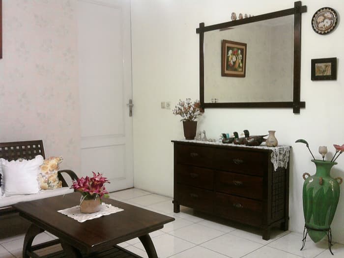 The flow of feng shui is evident with the use of this mirror. Notice it is near the front door, but doesn't reflect it.