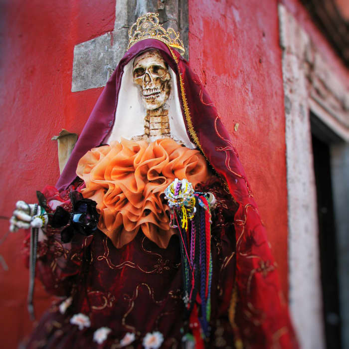 La Santisima Muerte is the Goddess of Death. Her image should be feminine ... the more feminine and beautiful, the better.