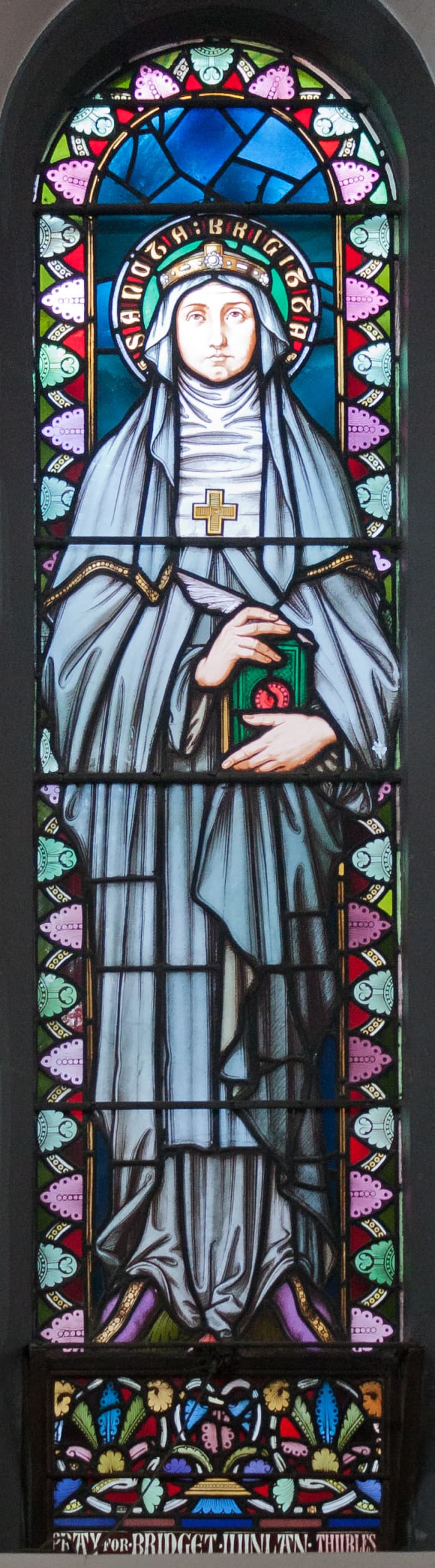 21st stained glass window in the ambulatory depicting Saint Brigid. Manufactured by Wailes of Newcastle.