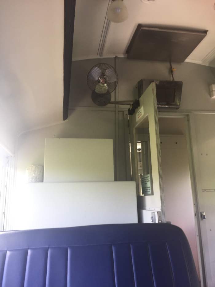 The carriage with the blue seats originally carried 'first class' passengers. There's nothing fancy about the fan, the heater and the light compared to the 'economy' carriage. However, the seats are much more comfortable.