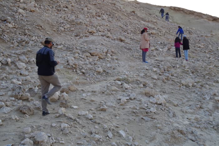 Some members of the entourage climbing up the barren and rocky hill (December 2015).