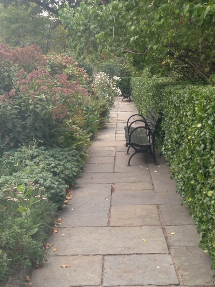 Enjoy a delightful nook for free in Central Park's colorful Conservatory Garden.