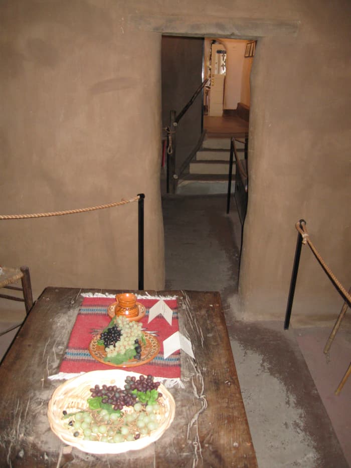 Dinner table with period food inside Santa Fe's Casa Vieja de Analco