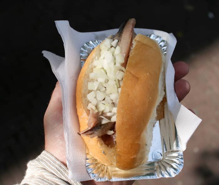"Hollandse Nieuwe," or soused herring, is a Dutch specialty. I personally LOVE eating this, but some people think it's gross!