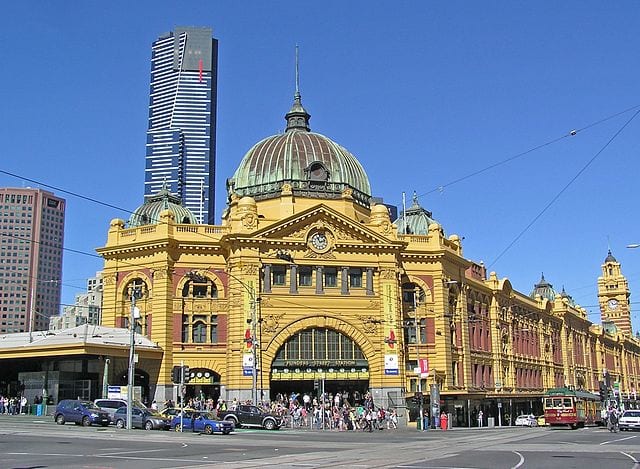 Historic Flinders Street Station, Australia's first railway station, with the Eureka Tower skyscraper in the background.