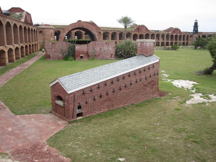 The fully-restored hot-shot furnace, with one of the fort's 37 powder magazines behind it