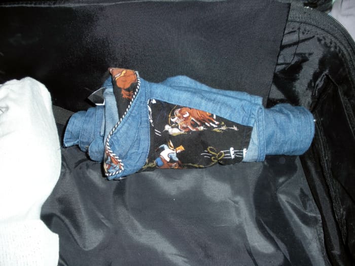 There are no creases but one up the center of the back as if ironed, when rolling clothes, and it's really not that noticeable