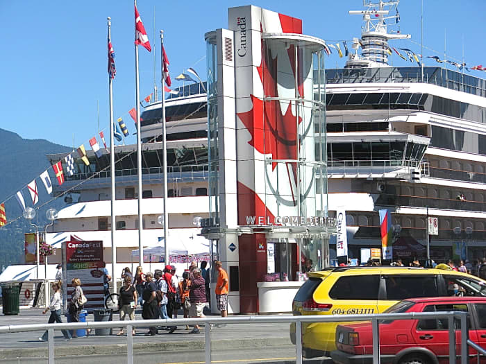 Canada Place entrance with a cruise ship; the building with the large maple leaf is the welcome centre