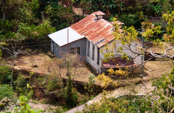 Abandoned building beside the stream, lucky to survive Mitch. Flagpole indicates it may have been a school or government building.